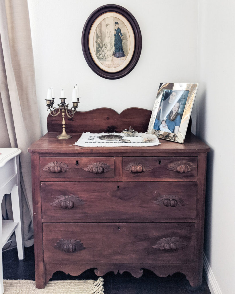 A small Eastlake chest of drawers with a carved back, two small drawers up top, and two larger drawers on the bottom. Loved old furniture is the essential building block of a grandmillennial home.