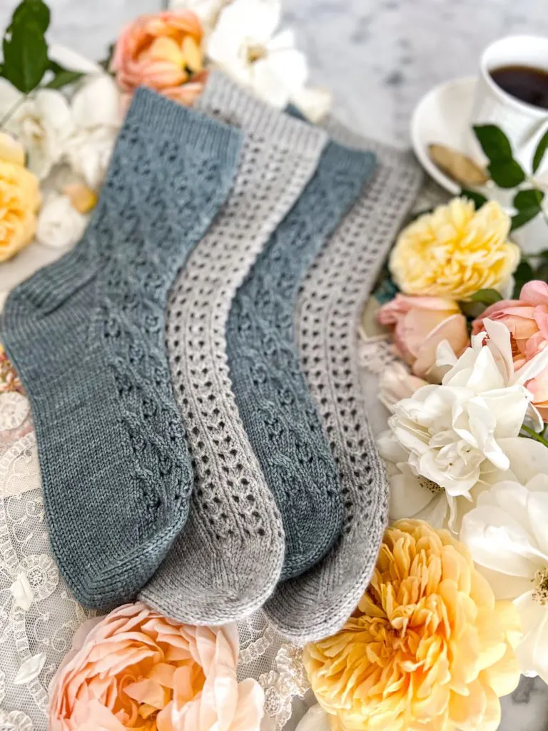 Four socks, stacked on each other in alternating blue and gray, photographed from the toes.