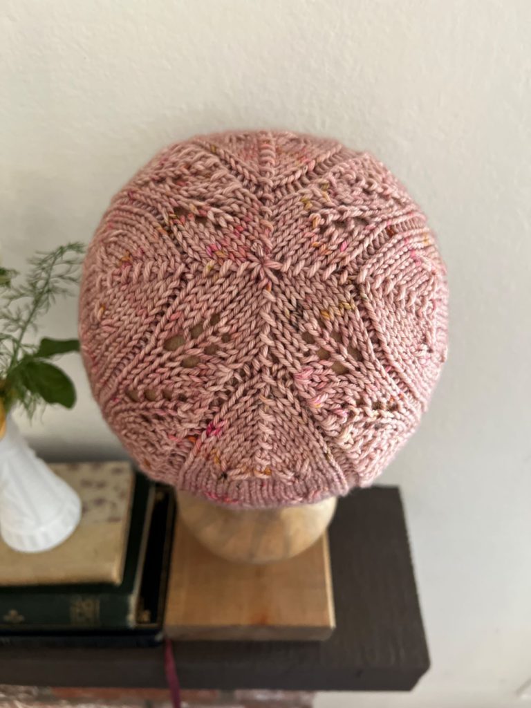 A close-up of the crown of the Profiterole Hat, showing four panels coming together in the center to form a star-like symmetrical shape.