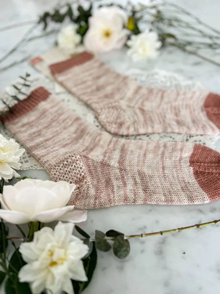 A close-up on the heel and gusset of a simple handknit sock. It shows the plain stockinette texture and Eye of Partridge heel.