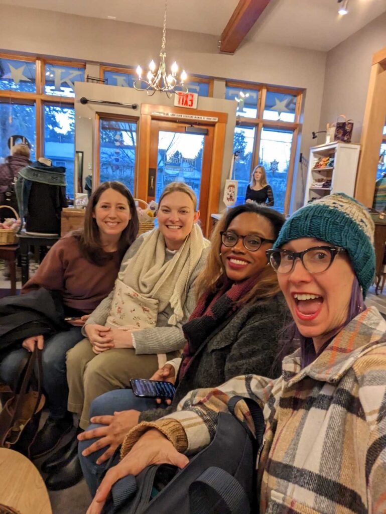 Four fiber friends bundled up in our natural habitat: a yarn shop. From left to right is Emily, me, Britt, and Beth. We're all grinning from ear to ear.