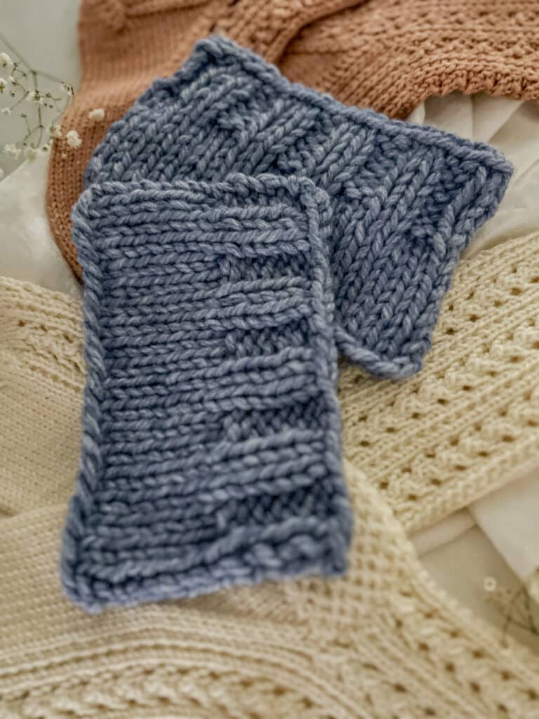 A close-up on the bound-off edge of a knit swatch with ribbing on the edge that has been bound off in pattern. This shows that binding off in pattern creates a slightly more ripply, nuanced edging that better matches the flow of the ribbing.